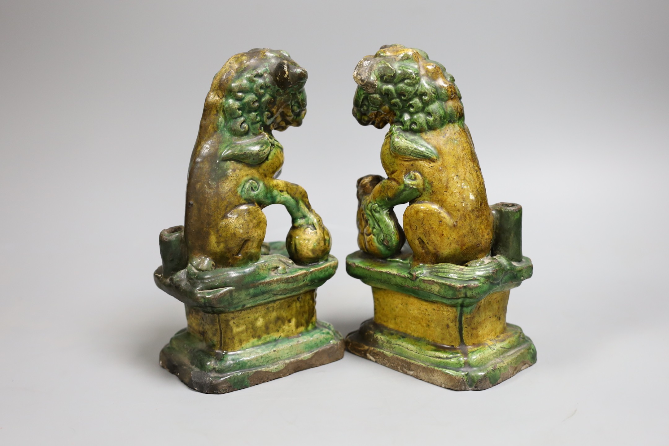 A pair of Chinese sancai lion dog joss-stick holders, late Ming dynasty, 20cm high